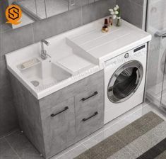 a washer and dryer in a bathroom with grey tile flooring on the walls