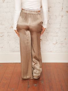 Our Nikita Satin Pants offer effortless style with their high-rise, relaxed fit, and wide-leg silhouette. Featuring a satiny feel and elastic waist, they’re both chic and comfortable. Pair them with a fitted top and heels for a sleek look that’s perfect for a night out or a special event! Details High Rise Elastic Waist Front Pockets Wide Leg Relaxed Fit Satiny Feel Size recs: 2-4 Small, 4-6 Medium, 8-10 Large Provides lots of stretch in waist Model is 5'4" wearing a size Small Quilted Outerwear, Fall Wedding Guest, Wedding Guest Looks, Satin Pants, Event Details, Skirt Co Ord, Fitted Top, Jumpsuit Shorts Rompers, Short Jumpsuit