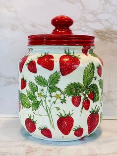 a jar with strawberries painted on it