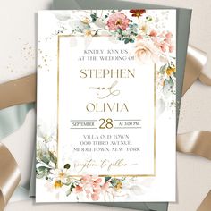 an elegant wedding card with flowers and gold foil