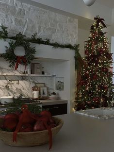 a kitchen decorated for christmas with a large tree in the corner and decorations on the counter