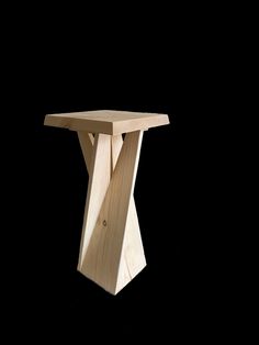 a small wooden table on a black background