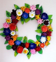 a paper flower wreath hanging on the wall