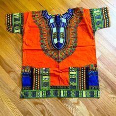 Colorful African Dashiki Top Size Large New Never Worn. Orange Vibrant Print Short Sleeve Tops, Vibrant Orange Printed Top, Vibrant Orange V-neck Top, Traditional Orange Cotton Tops, Orange Bohemian Cotton Top, Orange Cotton Festival Top, Bohemian Orange Tops With Vibrant Print, Colorful Orange Tops For The Beach, Orange Bohemian Top With Colorful Pattern