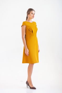 "A midi mustard dress featuring a line silhouette, draped bodice and cap sleeves. - draped bodice - a line silhouette - cap sleeves - scoop neck - knee length (midi) - two pockets in side seams - premium italian fabric Color: yellow (mustard) Fiber: viscose - 60%, elastan - 5%, polyester - 35% Concealed back zipper closure For Size S (6 US): dress length - 39\" (101,5 cm) Our model wears size S (US 6) and is 171 cm/5'6\" tall. You may feel free choosing the size. Just send us your measurements ( Wedding Guest Dress Yellow, Sleeve Wedding Guest Dress, Yellow Wedding Guest Dresses, A Line Party Dress, Skater Dresses Casual, Mandarin Dress, Mustard Dressing, Yellow Wedding, Womens Cocktail Dresses