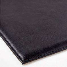 a close up view of a black leather surface