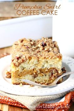 a piece of cake sitting on top of a white plate with a spoon in it