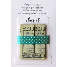 congratulations card for class of graduation with money wrapped in a green ribbon and polka dots