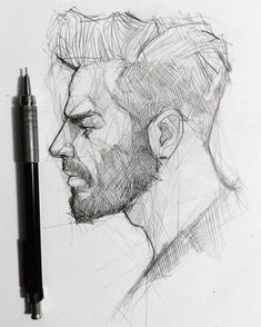 a pencil drawing of a man's face next to a ballpoint pen on paper