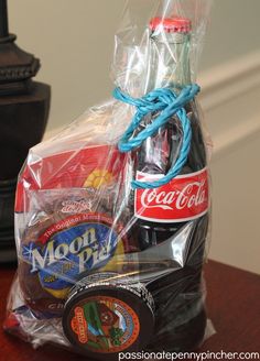 a plastic bag filled with soda and snacks