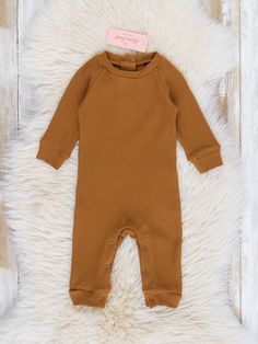 Ready for some fashion-forward fun? Our Ribbed Knit Crew Neck Romper is the perfect choice! Crafted from a buttery-soft ribbed fabric, this piece will have your little one looking cute and feeling comfy all in one. Rock on! Available in Russet, Charcoal, and White options.   Fits true to size. 95% Cotton / 5% Spandex Accessories sold separately. Import.   Miles is 11 lbs 4 oz and 23 inches long wearing 0/3 months. *Afterpay and Sezzle Purchases Require $35 Minimum Order. Soft Knit Sweater For Playtime In Fall, Cotton Ribbed Solid Color Sweater, Brown Cotton Ribbed Sweater, Casual Sweater For Playtime With Soft Knit, Casual Soft Knit Sweater For Playtime, Waffle Knit Sweater For Spring, Cute Solid Color Fall Sweater, Solid Ribbed Sweater For Spring, Basic Spring Sweater