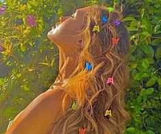 a woman with long hair and butterflies in her hair is looking up into the sky