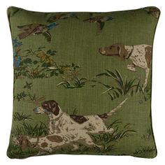 a green pillow with two dogs and birds on the front, one dog is laying down