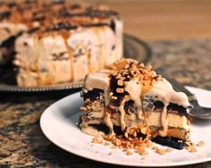 a piece of cake on a plate with a fork next to it and another pie in the background