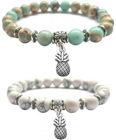 two bracelets with pineapple charms and beads on each one side, the other is white