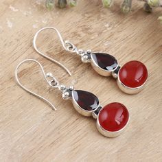 Faceted teardrops of garnet accentuate the smoothness of carnelian cabochons in these earrings designed by India's Neeru Goel. The bezel-set gemstones dangle from a trio of tiny sterling silver beads and swing freely from silver hooks. Elegant Carnelian Teardrop Earrings, Red Carnelian Teardrop Jewelry, Red Carnelian Teardrop Earrings, Sparkle Earrings, Sterling Silver Dangle Earrings, Sterling Silver Bead, Designer Earrings, Silver Beads, Garnet