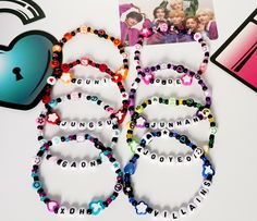 XDINARY HEROES CUSTOM BEAD BRACELETS Calling all Villains, want to show off your love for XDH? These custom bead bracelets are a must-have! These personalizable kpop bracelets are made with a variety of acrylic and plastic beads, including seed beads, butterfly beads, heart beads and star beads. We make each one by hand so the final product may not look exactly like the photo but it will have the same overall aesthetic.  Each bracelet is made using double-layered elastic string and measures appr Xdinary Heroes Outfit Inspired, Book Bead Bracelet, Personalized Multicolor Beaded Bracelets In Kpop Style, Personalized Multicolor Beaded Bracelets Kpop Style, Kpop Style Adjustable Beaded Bracelet For Birthday, Handmade Kpop Beaded Bracelets For Gifts, Personalized Kpop Beaded Bracelets, Kpop Style Beaded Bracelets As Gift, Kpop Style Personalized Multicolor Bracelets