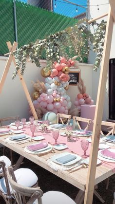 a table set up with balloons and plates