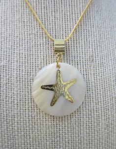 "14 k Gold Starfish sealed on white Abalone pearl disc pendant,  1.5 \" circle,14K gold 18\" chain w/ lobster closure and ext.  The etched gold starfish is sealed onto the beautiful white abalone pearl disc. The snake chain is slinky and comfortable to wear. Perfect for Mermaids everywhere!" Ocean-inspired Shell With Pearl Pendant For Beach, Shell-shaped Pearl Pendant Jewelry For Beach, White Shell-shaped Jewelry With Pearl Pendant, Seashell Jewelry Diy, Ocean-inspired Shell-shaped Pearl Pendant, Gold Shell-shaped Necklace With Starfish Charm, Starfish Necklace, Seashell Jewelry, Disc Pendant