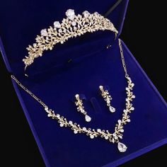 a tiara and earring set in a blue velvet box with jewelry on it