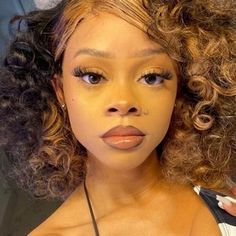 a close up of a woman with curly hair