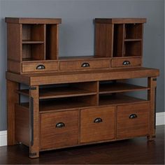 a wooden dresser with two open doors and drawers on it's sides, in front of a gray wall