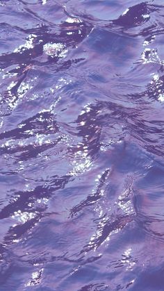 the water is very blue and purple with some light reflecting off it's surface