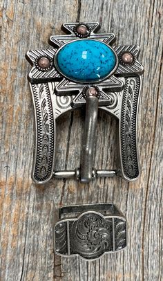 An antique silver south western concho that has a large turquoise center and a touch of blonde turquoise. Measures 1.5" x 1.25" Paired with our custom copper buckle adapter and keeper set. This buckle measures 2" X 1.5" and is designed to fit leather that measures anywhere from 5/8" to 3/4". Perfect for headstalls, dog collars, and much more. Southwestern Concho Belt Buckles For Ranch, Bohemian Concho Belt Buckles For Western-themed Events, Blue Concho Western Belt Buckles, Adjustable Western Concho Belt Buckles, Silver Hand Tooled Adjustable Belt Buckles, Western Style Blue Concho Belt Buckles, Adjustable Silver Hand-tooled Belt Buckles, Adjustable Southwestern Concho Belt Buckles, Southwestern Antique Belt Buckle For Rodeo