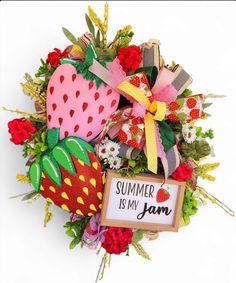 a wreath with strawberries, flowers and a sign that says summer is my jam