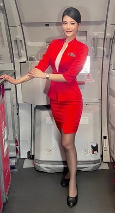 a woman in a red flight attendant's uniform