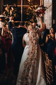 a bride and groom walking down the aisle