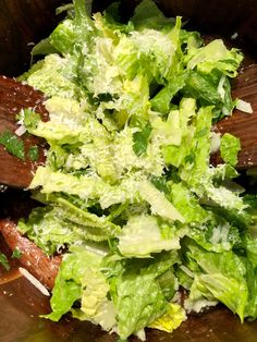 lettuce in a wooden bowl with parmesan cheese