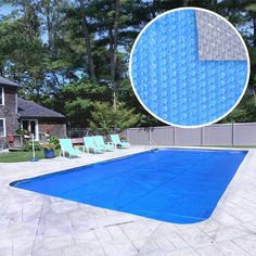 a large blue swimming pool surrounded by trees and lawn chairs in front of a house