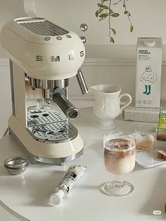 an espresso machine sitting on top of a white table