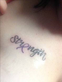 a woman's chest with the word happy written on her left side ribcage