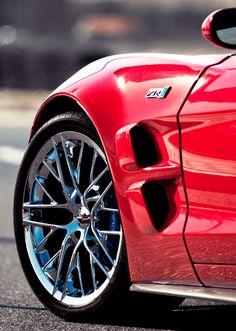 the front end of a red sports car