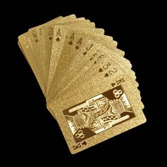 four gold playing cards with black background