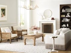 a living room filled with furniture and a fire place in the middle of a room