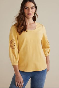 Our cozy French terry fabric meets chic detail. Perfect for adding extra style to your everyday wardrobe, this scoop neck pullover's sleeves are accented with embroidered cutouts. Relaxed Fit Embroidered Tops For Loungewear, Casual Crew Neck Top With Embroidered Sleeves, Floral Embroidered Tops For Spring Loungewear, Spring Loungewear Tops With Floral Embroidery, Spring Floral Embroidered Tops For Loungewear, Embroidered Tops For Spring Loungewear, Spring Embroidered Tops For Loungewear, Spring Cotton Knit Top With Crew Neck, Relaxed Fit Tops With Embroidered Long Sleeves