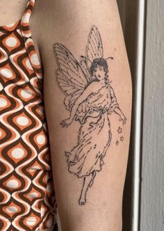 a woman's arm with a tattoo on it that has a drawing of a fairy