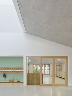 an open kitchen and living room are shown in this image, with the ceiling painted white