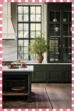 an image of a kitchen setting with green cabinets and pink checkerboard pattern on the wall