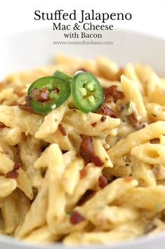 a white bowl filled with macaroni and cheese topped with jalapenos