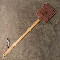 a wooden spatula sitting on top of a cement floor