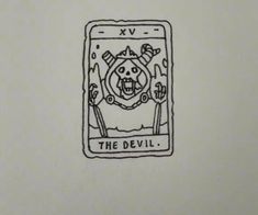 the devil tarot card is drawn in black ink on a white paper with some writing underneath it