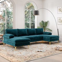 a living room with a large blue couch and rug in front of a big window