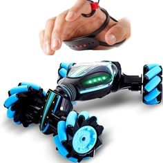 a hand holding a remote control toy that looks like a robot with lights and sound