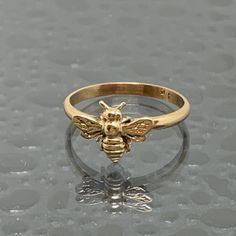 This is a 14kt solid gold Honey Bee Ring made in our studio in Ohio. These rings are available in various sizes and are made to order, so allow us a couple days extra for time in our studio. This ring will be a fantastic gift for yourself or that someone special. Keep in mind the Bee is very mischievous and can get caught in loose clothing and hair on occasion. We have tried various methods to eliminate this by offering the option of no antennae. Free Insured Priority Shipping to the US. Quirky Ring, Bee Ring, Bee Jewelry, Gold Bee, Fashion Statements, Authentic Jewelry, Girly Jewelry, Holiday Deals, Jewelry Inspo