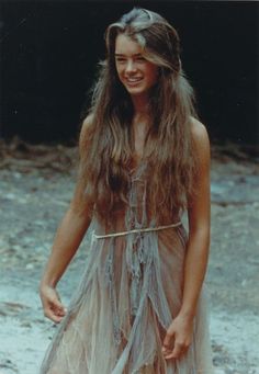 a young woman with long hair wearing a dress