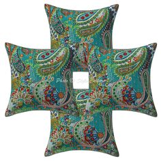 three decorative pillows with colorful paisley designs on the front and back, one in blue